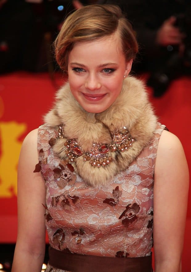 Saskia Rosendahl paired a delicate lace dress with a cozy furry neck warmer and added a touch of sparkle with some jeweled brooches for a unique and stylish look