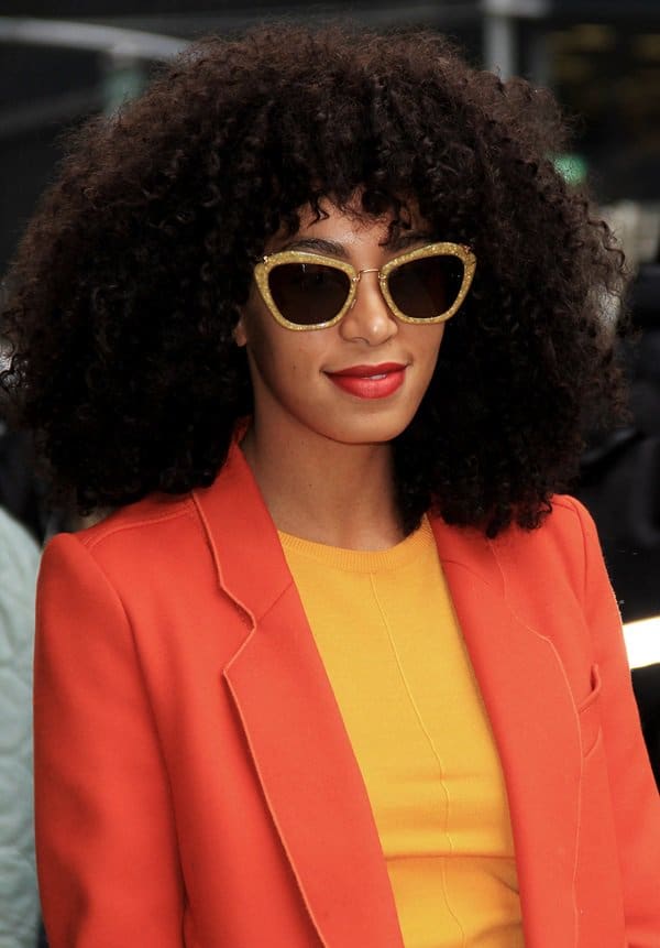 Solange Knowles dazzles with her choice of gold Miu Miu sunglasses, adding a touch of glam