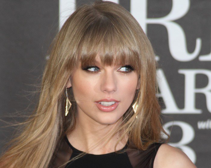 Eschewing her signature red lipstick, Taylor Swift opted for neutral makeup highlighted by smoky eyes