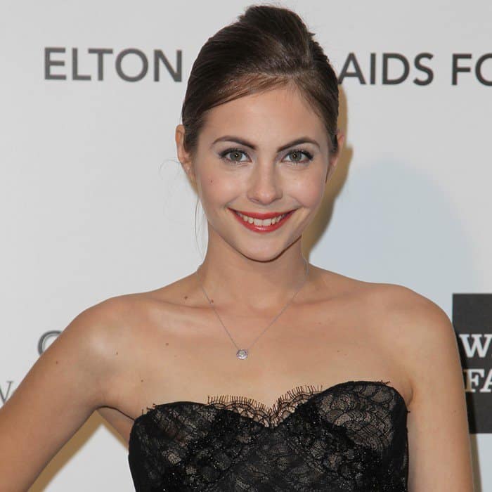 Willa Holland elegantly dons a layered black Marchesa gown, exuding sophistication and charm
