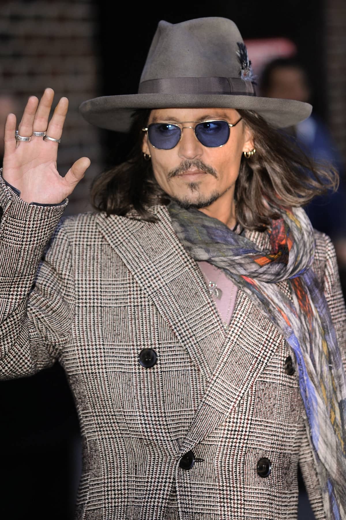 Johnny Depp elevated his unique style by accessorizing with a Faliero Sarti scarf, adding a touch of Italian luxury and sophisticated flair to his ensemble