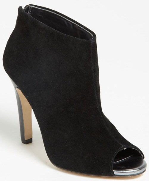 An open toe offers a glimpse of the metallic footbed inside a supple suede bootie