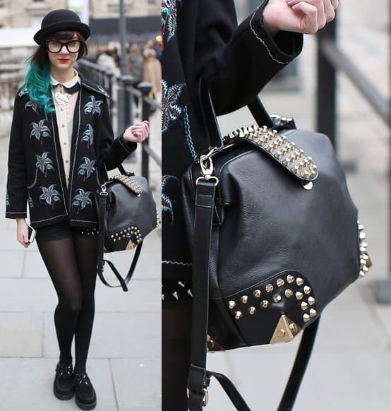 Pairing vintage charm with modern edge, this studded black satchel adds boldness to a whimsical embroidered jacket and classic bowler hat