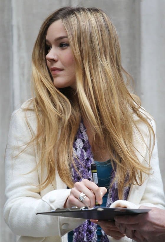 Joss Stone, radiant and approachable, exits the BBC Radio Two Studios, pausing gracefully to sign autographs for awaiting fans