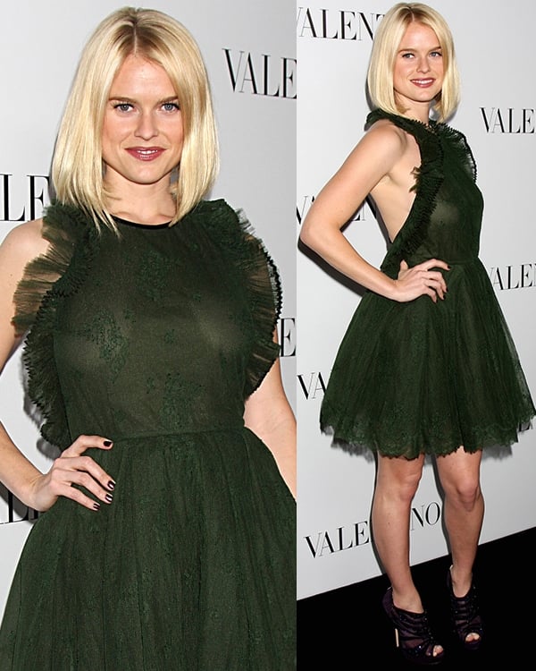 Alice Eve radiates in a forest green Valentino dress with ruffled detailing, perfectly paired with platform heels at a Valentino event