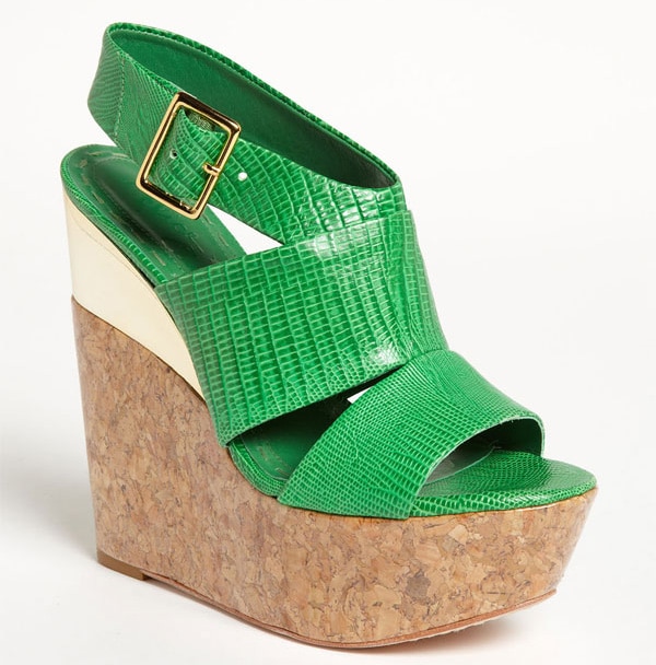 A quirky shot of modern metallic amps up an exultantly vivid, lizard-look sandal for a refreshing wardrobe finish.