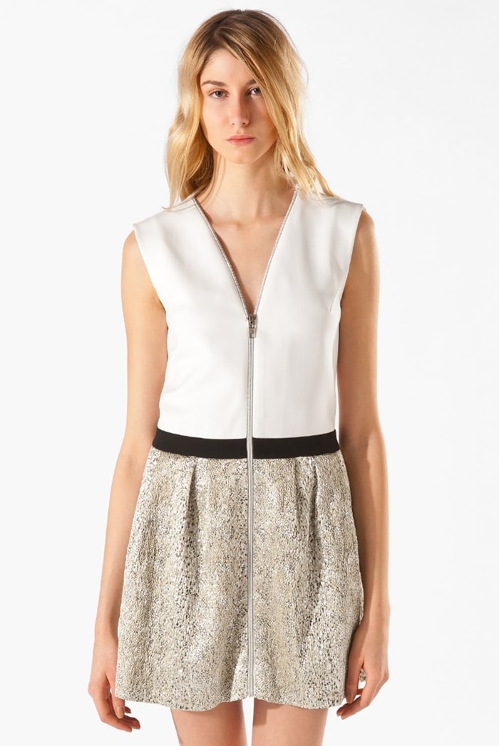 A deep V-neckline centers the full-zip front of a color-blocked, minimally pleated dress with a textured, metallic skirt