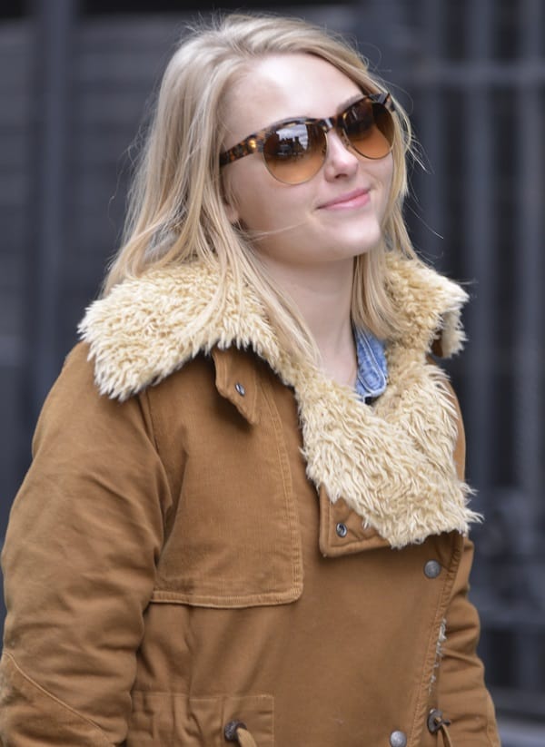 Embracing the New York chill, AnnaSophia Robb, star of The Carrie Diaries, wraps up in a statement shearling coat during a casual stroll through SoHo
