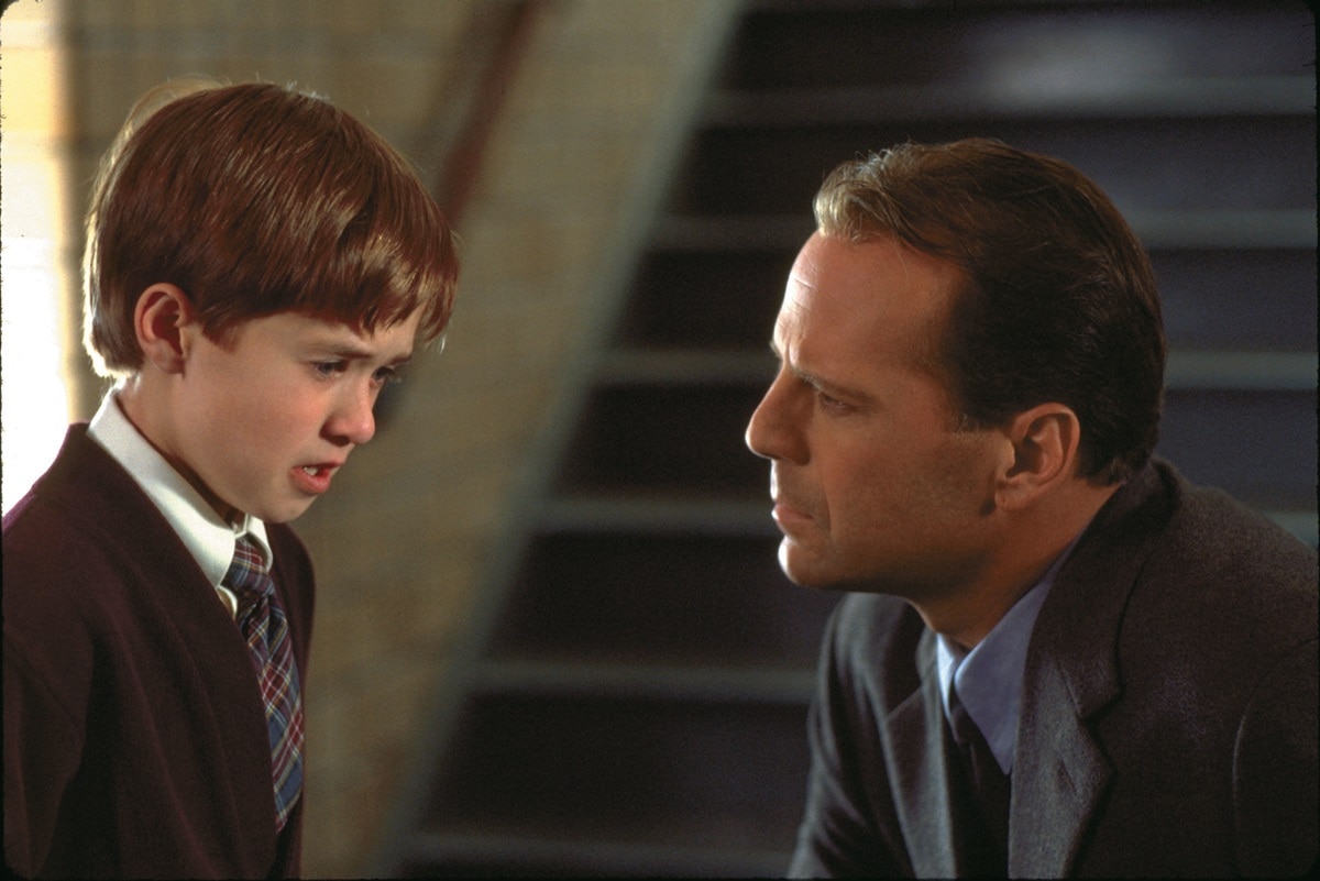 Bruce Willis as Malcolm Crowe and Haley Joel Osment as Cole Sear in the 1999 American psychological thriller film The Sixth Sense