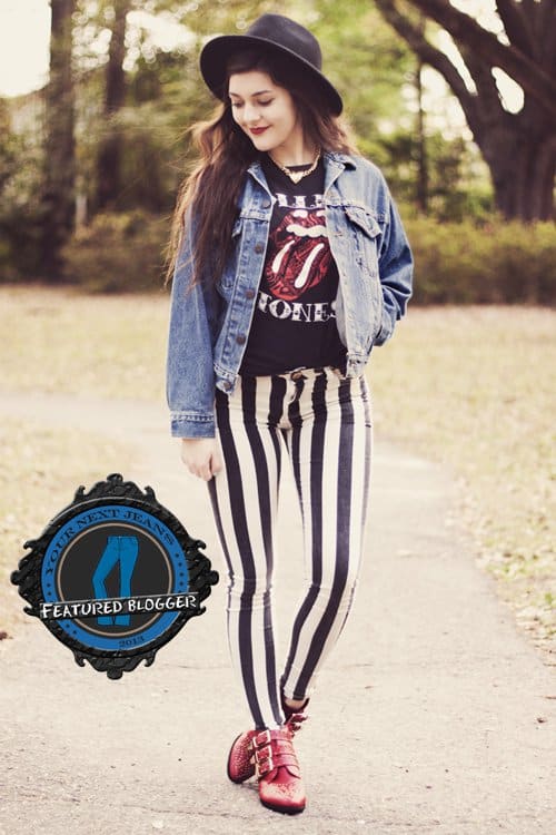 Carly wears black and white striped pants with a denim jacket