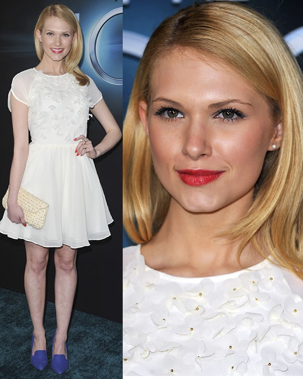 Claudia Lee looks elegant in a white floral-detailed dress paired with vibrant blue pumps, a cream clutch, and a soft red lip for a fresh and feminine ensemble