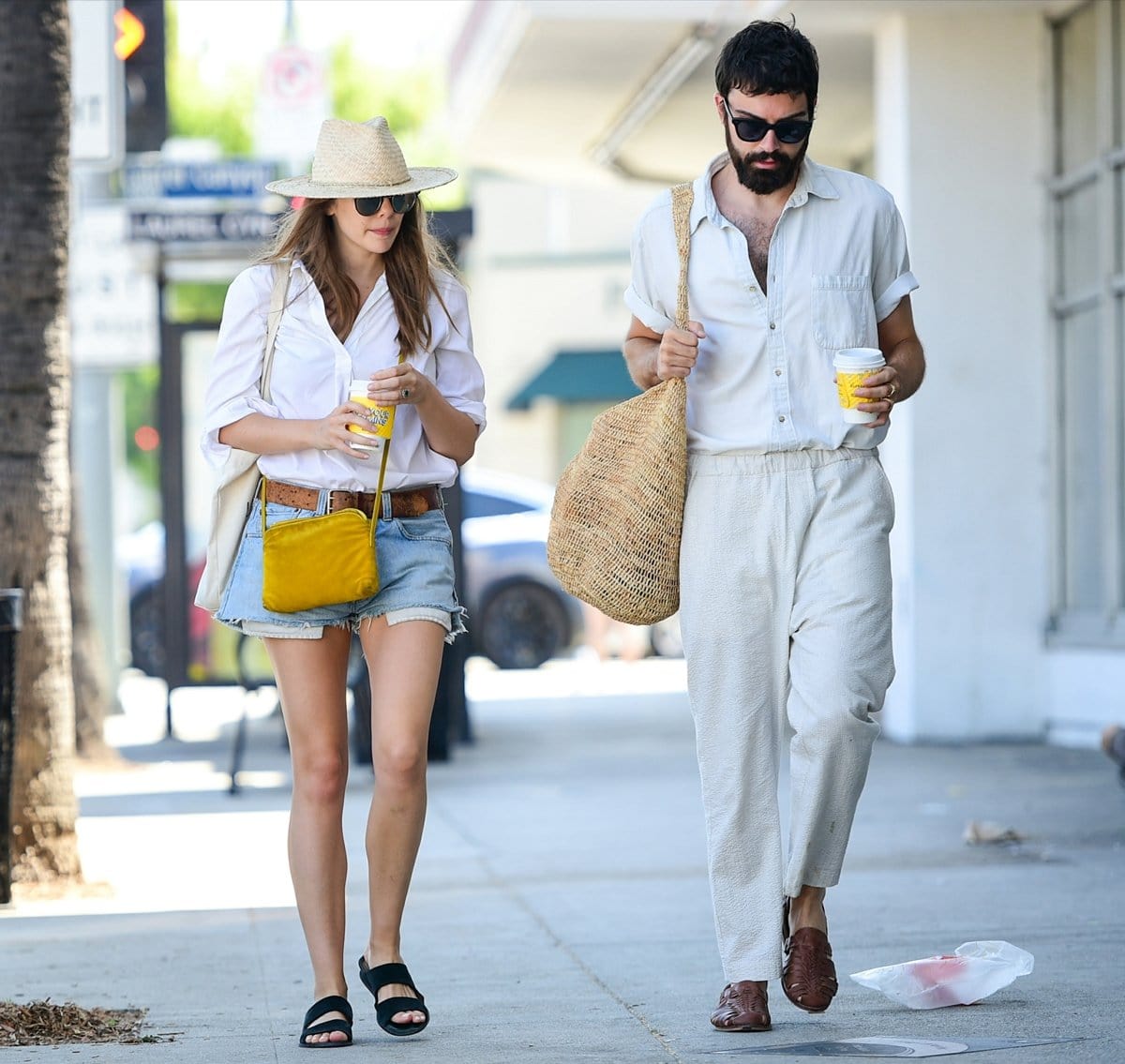 For her date with Robbie Arnet, Elizabeth Olsen wore Birkenstock sandals with a white button-down shirt, Daisy Dukes, and Garrett Leight sunglasses