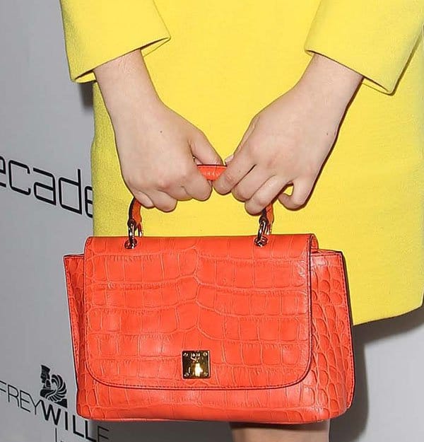 Isabelle Fuhrman totes an orange MCM 'First Lady' crocodile satchel