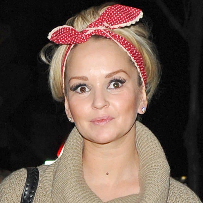 Jennifer Ellison brightens up a chilly day with a vibrant red and white polka-dotted headscarf, adding a splash of color and retro charm