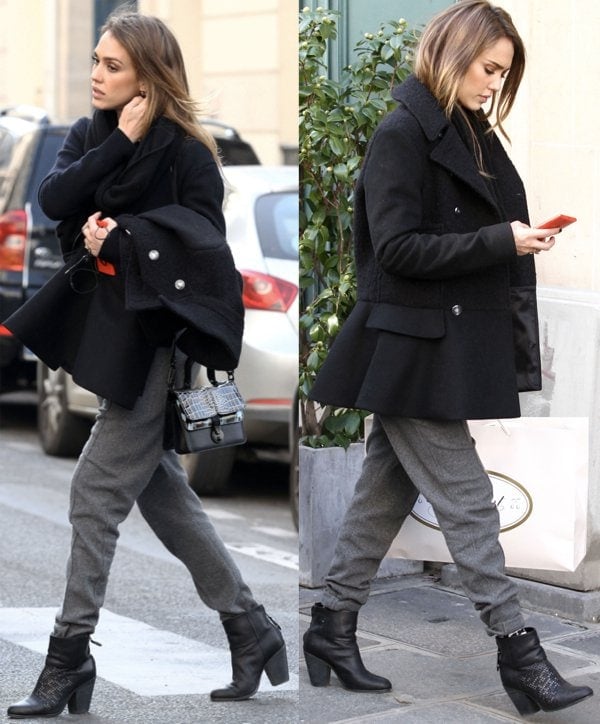 Jessica Alba goes colorless in a black coat and gray jogger pants during a Paris shopping trip