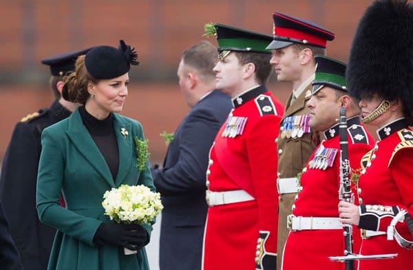 Catherine, Duchess of Cambridge (aka Kate Middleton) hands out shamrocks to the Irish Guards at Mons Barracks during the St Patrick’s Day military parade in Aldershot on March 17, 2013