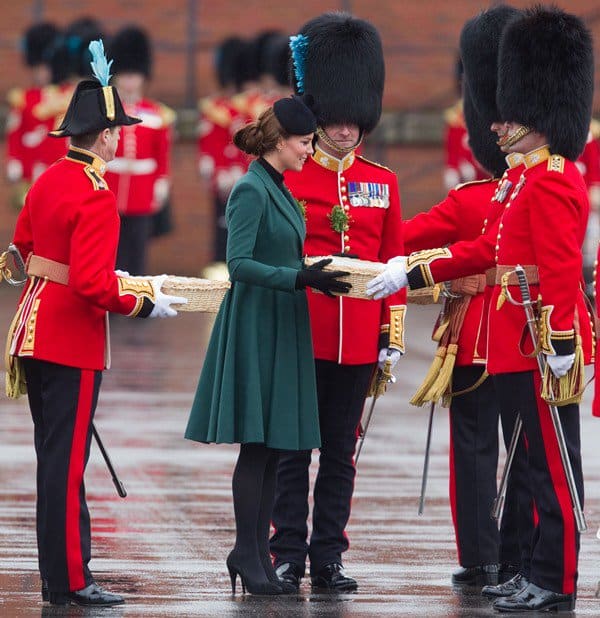 Catherine, Duchess of Cambridge (aka Kate Middleton) dressed in a deep green coat and black tights