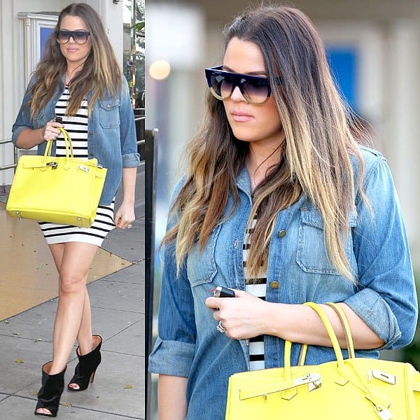 Khloe Kardashian wears a perfectly faded denim button-down while leaving On the Thirty restaurant