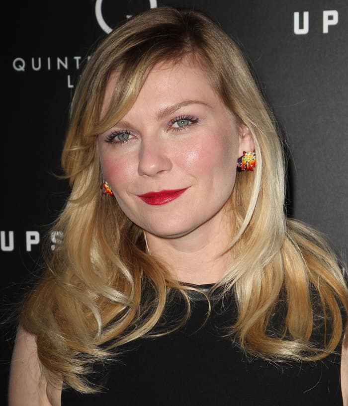 Kirsten Dunst elevates premiere look with vibrant gemstone earrings by Dior