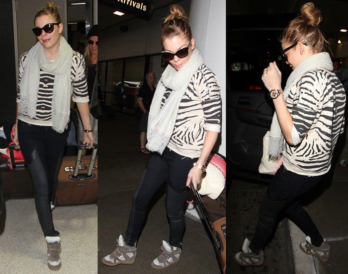 LeAnn Rimes arrives at LAX in style: pairing trendy sneaker wedges with sleek black paneled skinnies and a bold zebra-print sweater, March 18, 2013