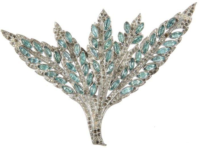 A simulated diamond and aquamarine costume ornament in foliate design. It was worn by Jean Harlow as a closure for an evening cape in "Libeled Lady," a 1936 screwball comedy film