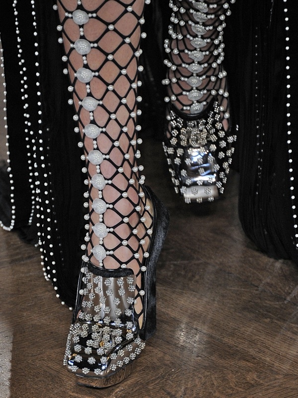 Model wearing pearl-embellished knee-high gladiator heels