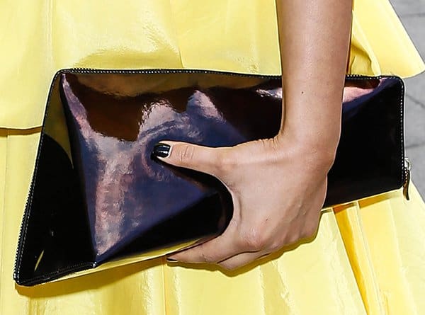 Nazaneen Ghaffar turns heads at the TRIC Awards with her uniquely asymmetrical patent clutch, a testament to bold accessorizing