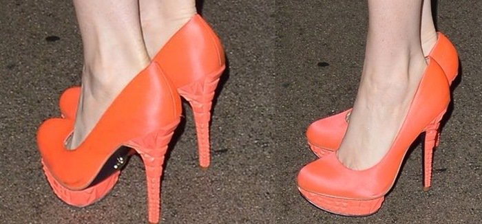 Phoebe Price shows off the orange detailing on her bright Rachel Roy pumps