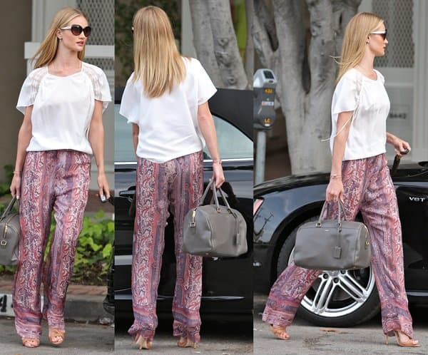 Rosie Huntington-Whiteley epitomized bohemian chic in West Hollywood on March 25, 2013, wearing Isabel Marant Sydney printed silk-gauze wide-leg pants, a Chloe embroidered print blouse, Brian Atwood Temptation sandals, Prada 04ms sunglasses, and a Saint Laurent Classic Duffle 6 leather bag
