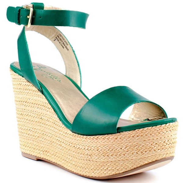 A woven wedge lifts an ankle-wrap sandal to breezy, walkable heights
