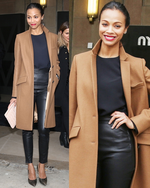 Zoe Saldaña in a camel trench coat, a navy top, and high-waisted leather skinnies