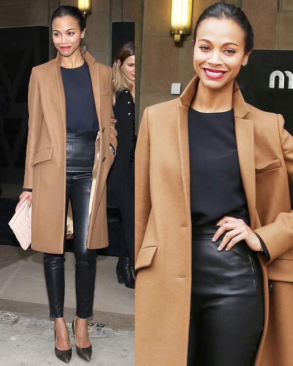 Zoe Saldana in a camel trench coat, a navy top, and high-waisted leather skinnies