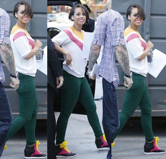 Alicia Keys wears dark green jeans and color-block wedge sneakers