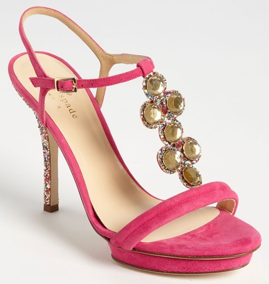 The "Velvet" sandals are a deep pink suede pair embellished in faceted stones and confetti glitter.