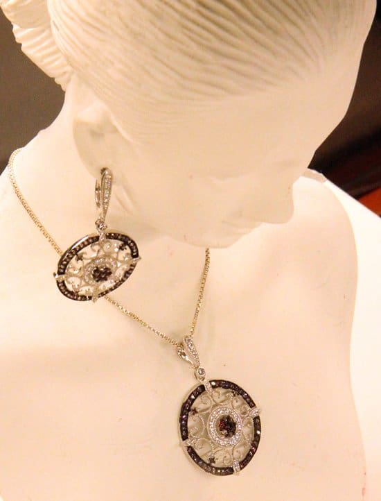 Purple gems are the center of this elaborate necklace and earring set