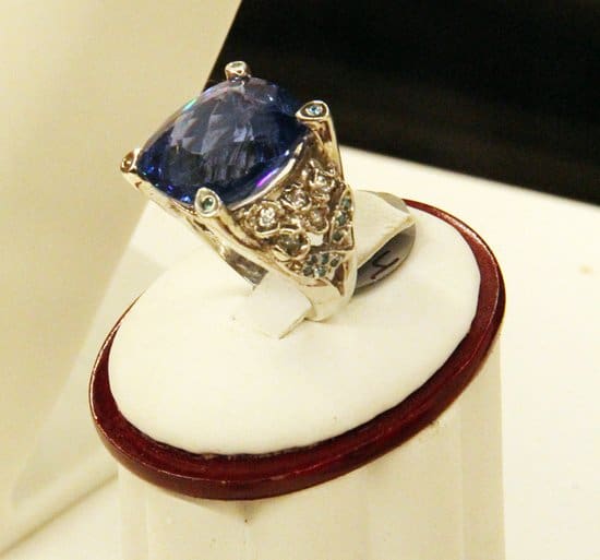 Michael Raven's James Brown Jewelry Collection features this intricate gold ring set with a large purple-blue gem