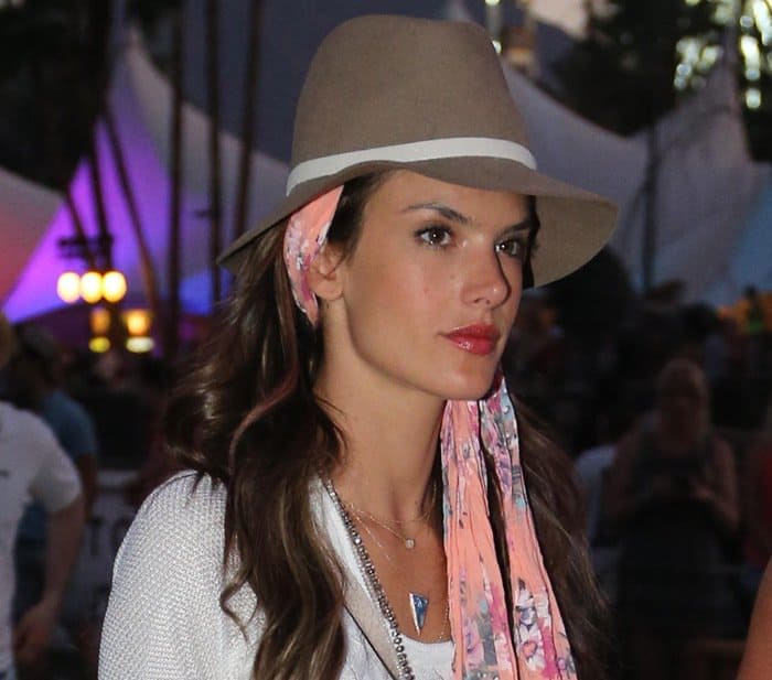 Alessandra Ambrosio wears a printed peach head scarf and a floppy hat