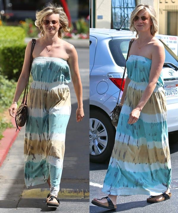 Amy Smart exudes summer charm in a strapless tie-dye maxi dress paired with casual sandals and a stylish cross-body purse
