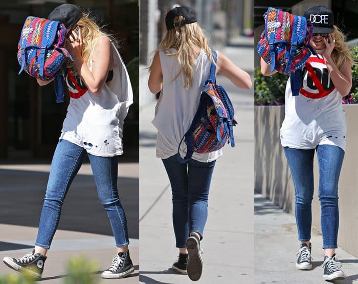 On April 25, 2013, in Los Angeles, Ashley Benson was spotted dining with a friend, styled in a casual yet edgy ensemble featuring Converse Chuck Taylor All Star Core Hi sneakers, a Dope Couture snapback, Karen London rings, Wildfox Steff sunglasses, an Ecote patterned collage backpack, and Goldsign Glam skinny jeans in Gracie