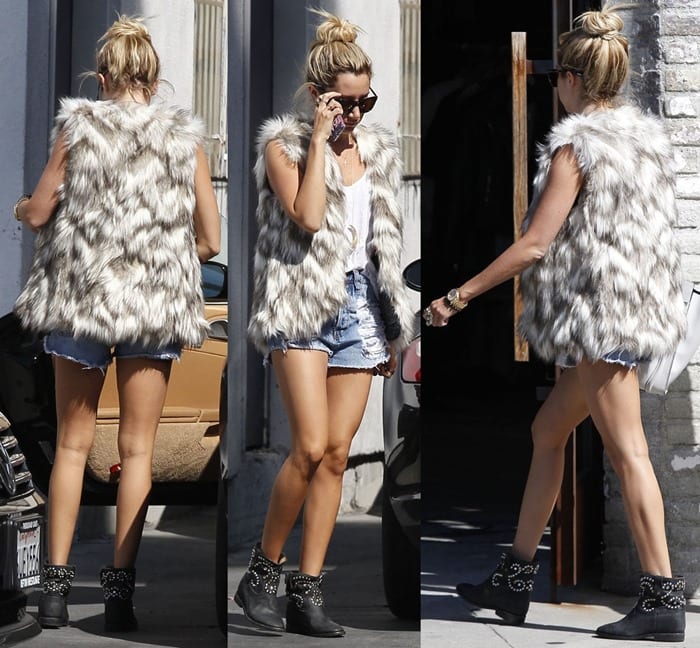 Ashley wore her boots with a tank top and cutoff shorts topped off with a fur vest