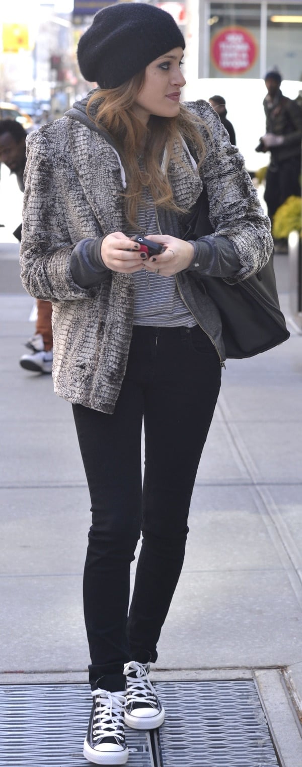 Carly Chaikin rocked a black knit beanie and toted an oversized black leather bag