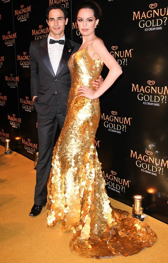 Zac Posen with Caroline Correa in his $1.5 million 24k gold dress at the "As Good As Gold" premiere, Tribeca Film Festival, NYC, April 2013