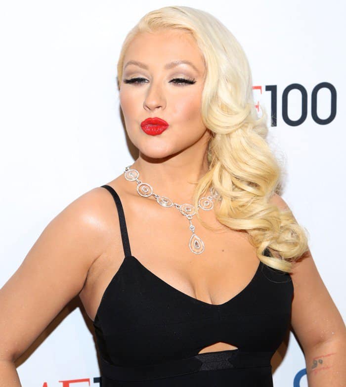 Christina Aguilera radiates elegance in a black Victoria Beckham dress at the TIME 100 Gala, showcasing her fit figure and fashion-forward style