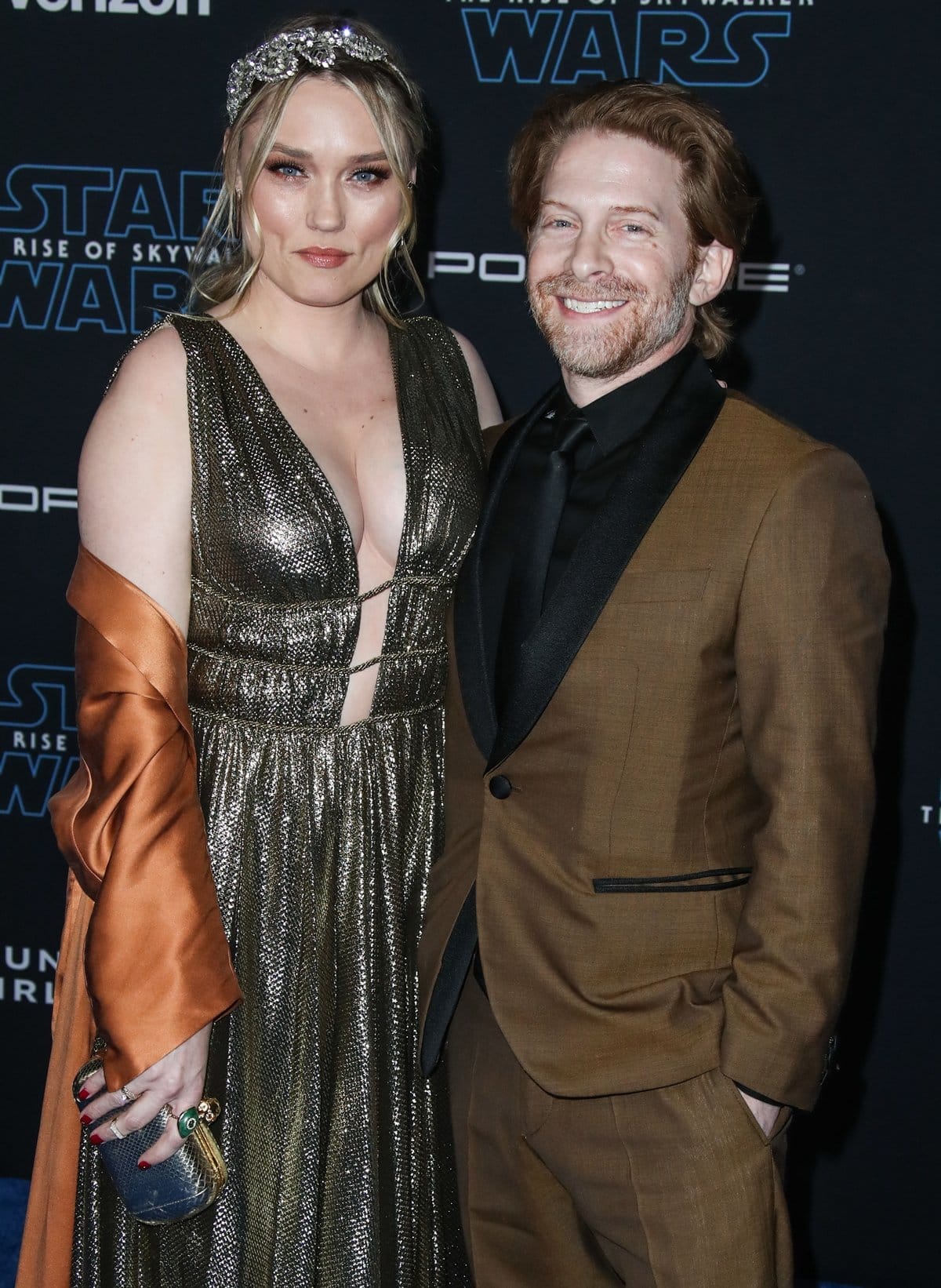 Clare Grant stuns in a metallic gown while posing with her husband, Seth Green, at the premiere of Star Wars: The Rise of Skywalker