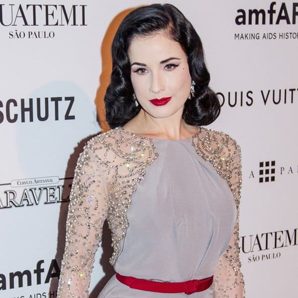 Close-up at elegance: Dita Von Teese showcases the intricate details of her Jenny Packham satin gown, featuring a sheer back and crystal-beaded sleeves, at the amfAR Gala in Sao Paulo, Brazil