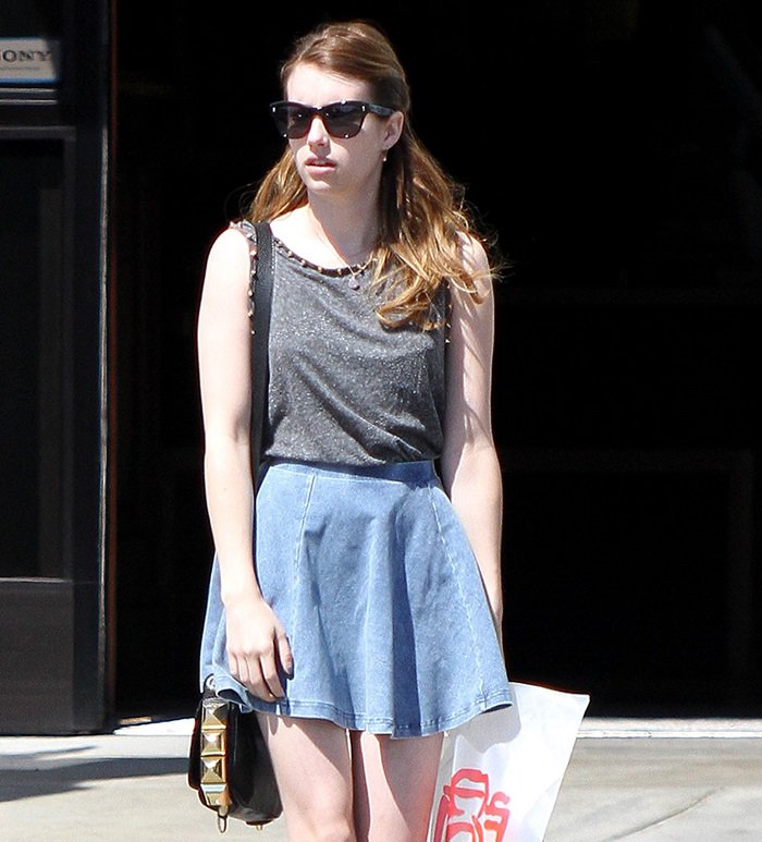 Emma Roberts in a denim skater skirt from Topshop with a spike detail tank top from the same brand