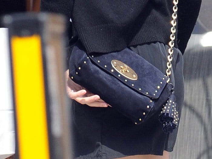 Close-up of Emma Watson's stylish ink blue Mulberry Lily tassel bag, a perfect blend of youthful elegance and functionality