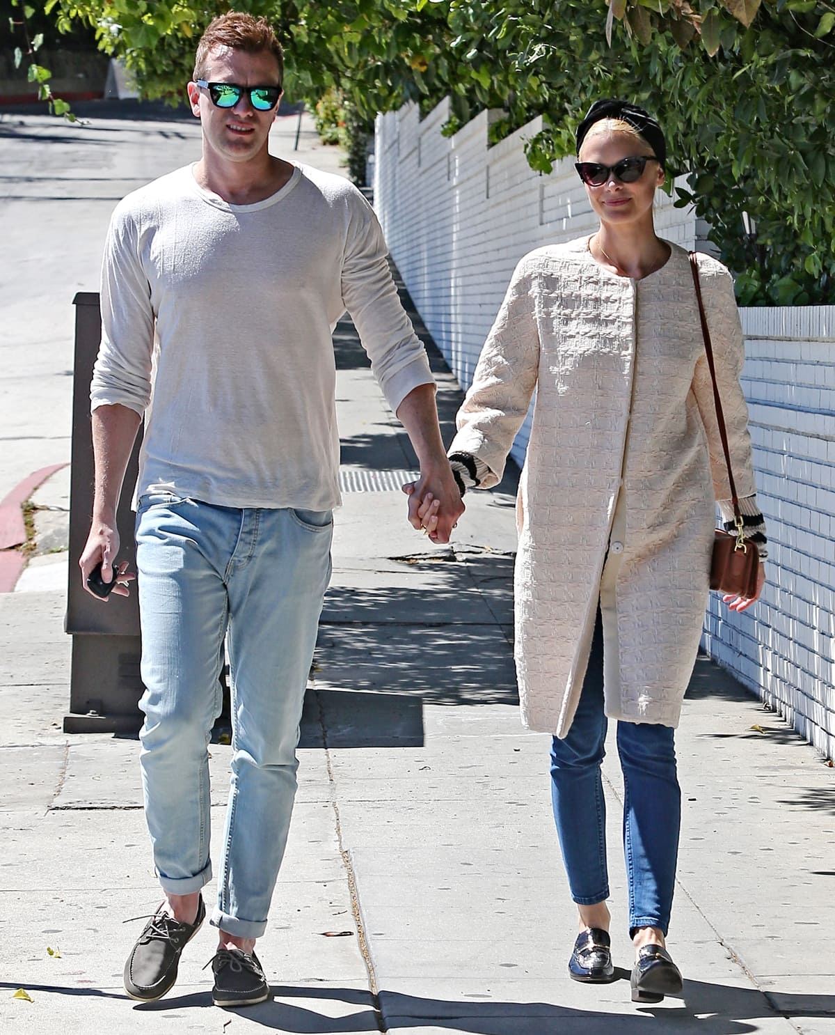 Jaime King and Kyle Newman, a visually striking couple due to their notable height difference, seen hand-in-hand in West Hollywood