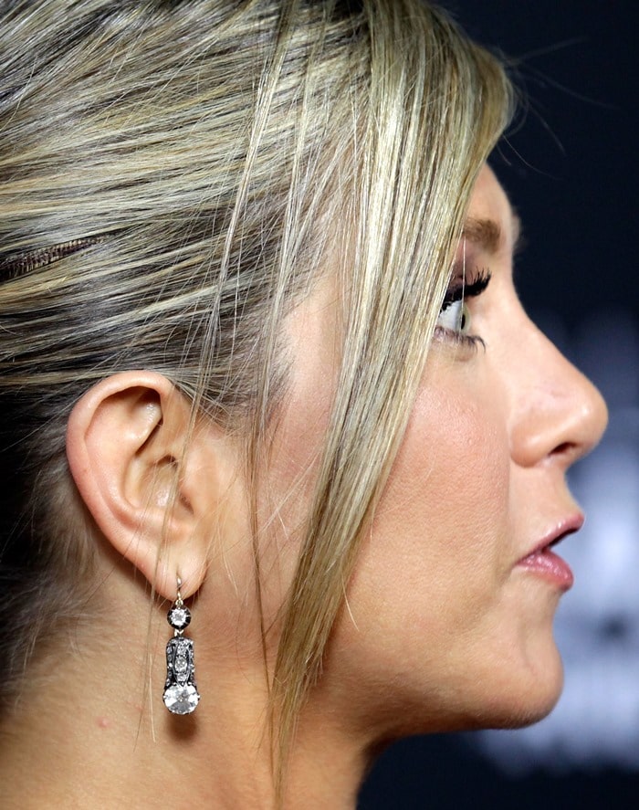 Jennifer Aniston showed off her earrings with a simple ponytail and side-swept bangs
