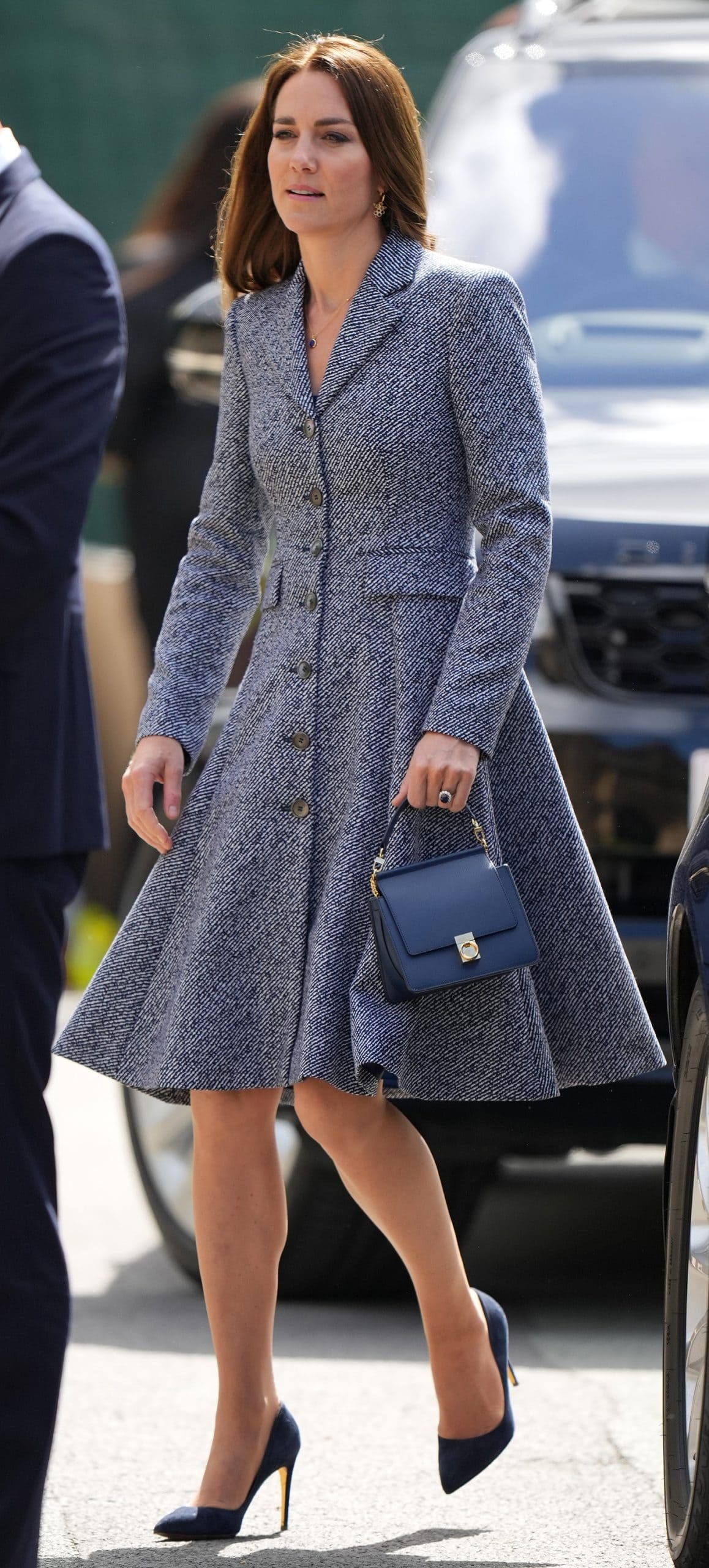 Kate Middleton wears a navy and white Michael Kors coat dress with Rupert Sanderson Malory pumps and a blue grain leather Polène Paris Numéro Sept (Seven) Mini handbag
